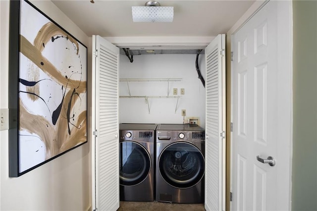 clothes washing area with separate washer and dryer