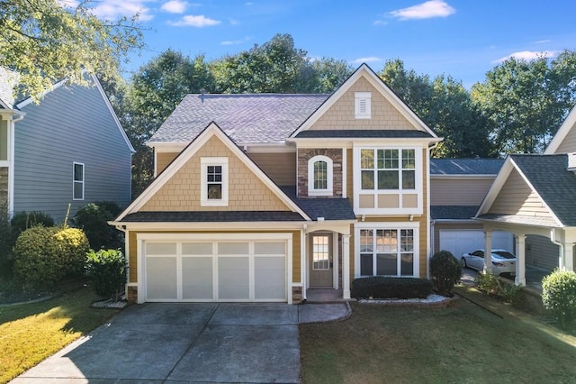 3277 Wyesham Cir, Duluth, GA 30096 - view of front of home with concrete driveway, a front yard, an attached garage, and a shingled roof