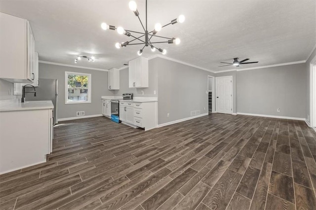 unfurnished living room with ceiling fan with notable chandelier, dark hardwood / wood-style flooring, and ornamental molding