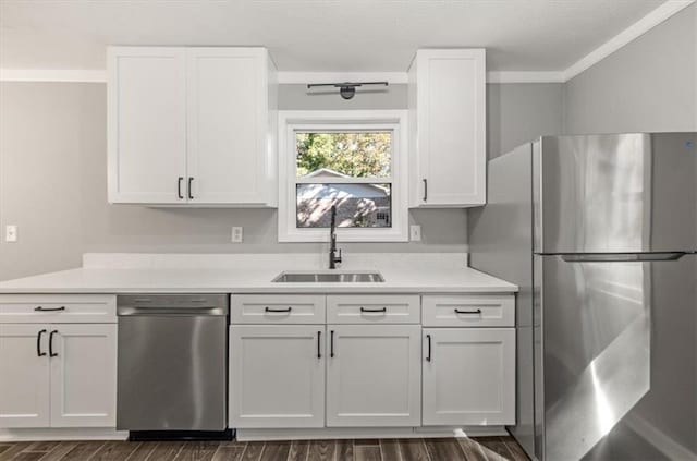 kitchen featuring stainless steel appliances, white cabinetry, dark wood-type flooring, and sink