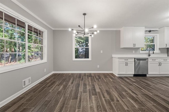 kitchen with stainless steel dishwasher, dark wood-type flooring, crown molding, white cabinets, and a chandelier