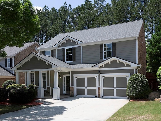 1535 Justine Way SE, Mableton, GA 30126 - view of front of property featuring concrete driveway, covered porch, a shingled roof, a garage, and fence