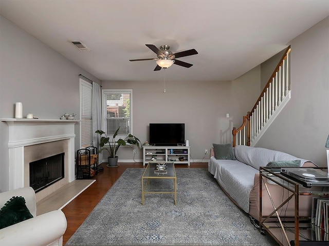 1535 Justine Way SE, Mableton, GA 30126 - living room with ceiling fan, stairs, wood finished floors, a fireplace with raised hearth, and baseboards