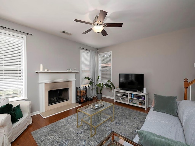 1535 Justine Way SE, Mableton, GA 30126 - living area featuring healthy amount of natural light, a ceiling fan, a fireplace with raised hearth, and wood finished floors