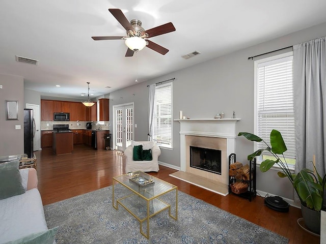 1535 Justine Way SE, Mableton, GA 30126 - living area featuring dark wood-style flooring, a fireplace with raised hearth, a ceiling fan, baseboards, and french doors