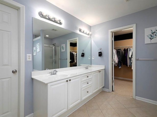 1535 Justine Way SE, Mableton, GA 30126 - bathroom featuring tile patterned floors, baseboards, a shower stall, double vanity, and a walk in closet