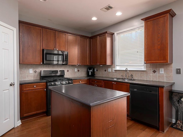 1535 Justine Way SE, Mableton, GA 30126 - kitchen featuring stainless steel appliances, a sink, dark countertops, wood finished floors, and recessed lighting