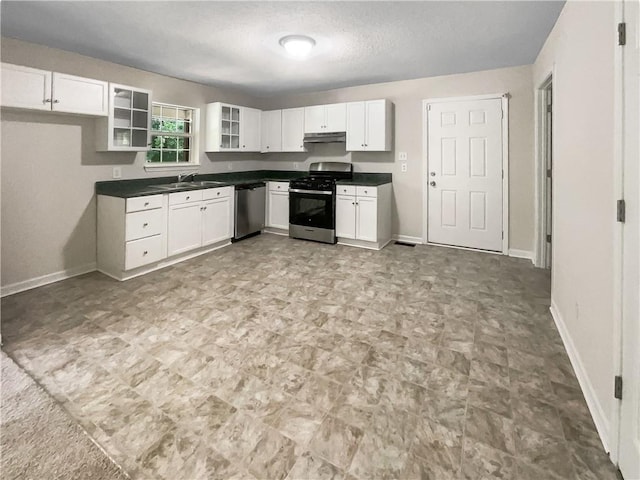 kitchen featuring sink, a textured ceiling, appliances with stainless steel finishes, and white cabinetry