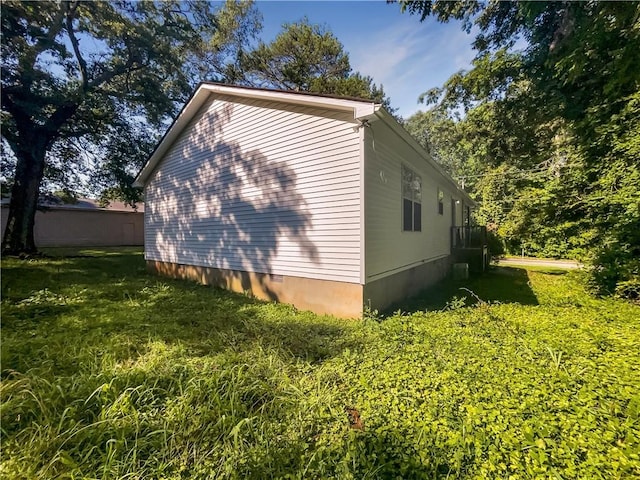 view of side of home featuring a yard