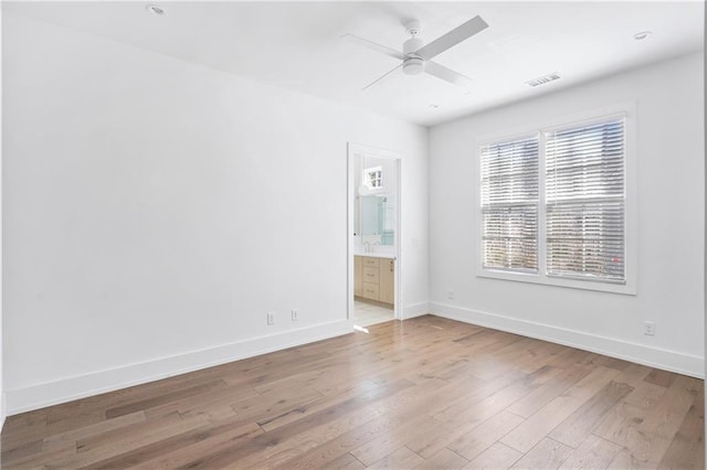 unfurnished room with light wood-type flooring and ceiling fan