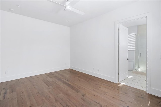 spare room with light hardwood / wood-style flooring and ceiling fan