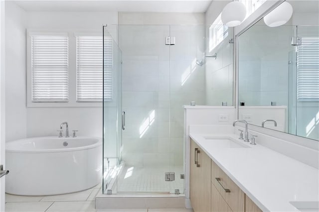 bathroom with tile patterned flooring, vanity, separate shower and tub, and a wealth of natural light