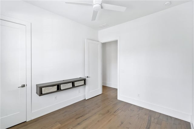 spare room with ceiling fan and hardwood / wood-style flooring