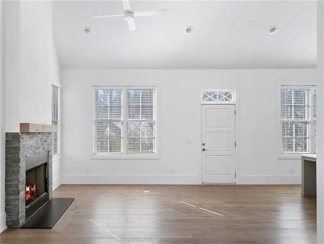 unfurnished living room with ceiling fan, wood-type flooring, and lofted ceiling