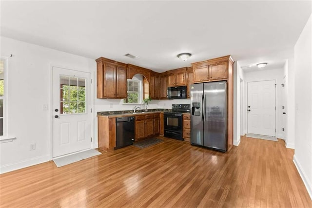 kitchen featuring wood-type flooring and black appliances