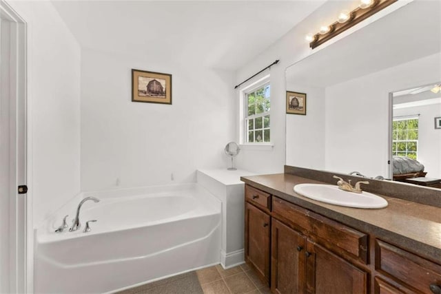 bathroom featuring vanity, a bathtub, and tile patterned floors