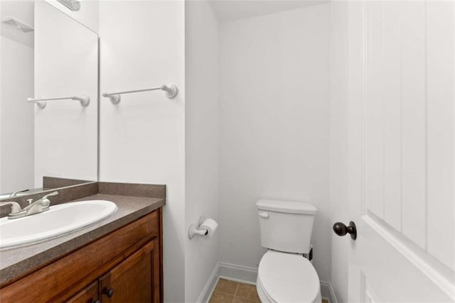 bathroom with vanity, tile patterned floors, and toilet