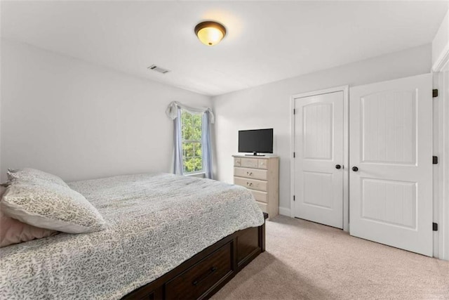 bedroom featuring a closet and light carpet