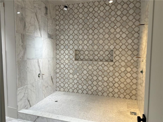 bathroom with a tile shower