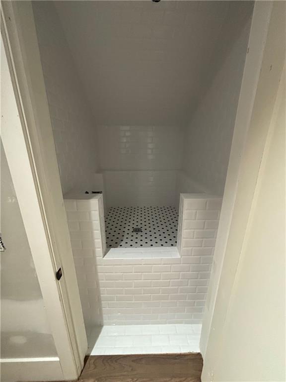 full bath with a tile shower