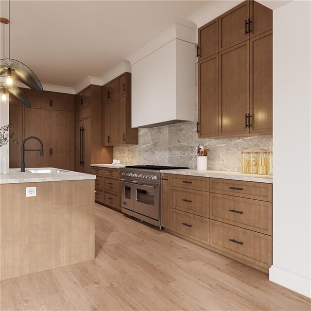 kitchen with tasteful backsplash, light countertops, a sink, light wood-type flooring, and double oven range