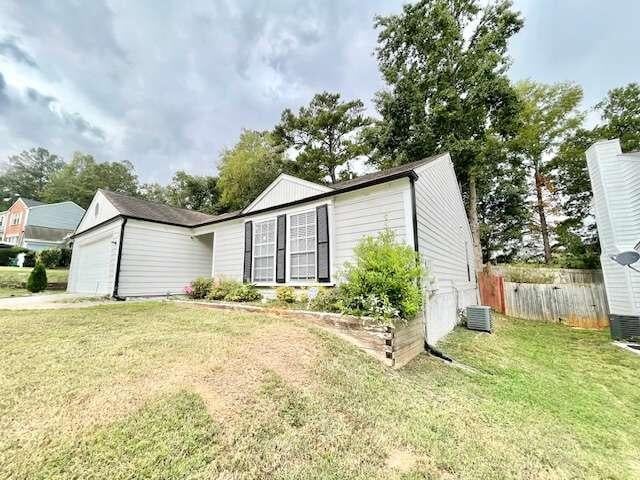 exterior space featuring a garage and a yard