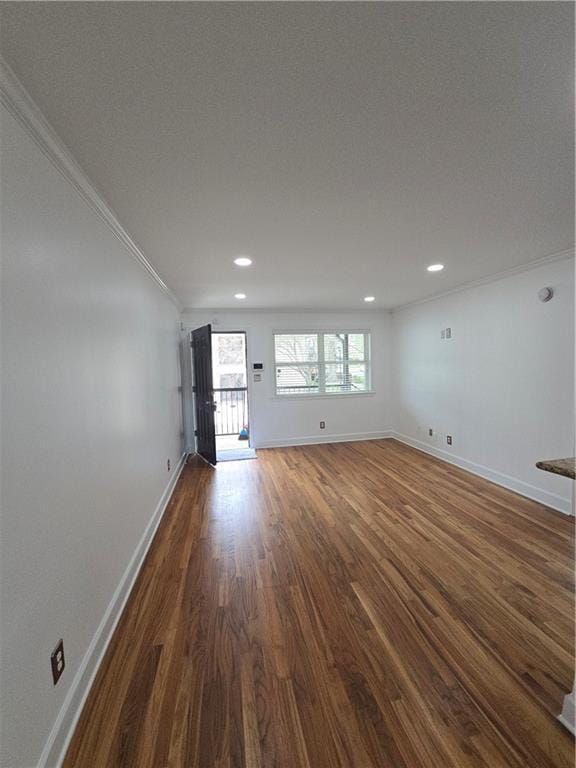 48 Peachtree Ave NE Unit 321, Atlanta, GA 30305 - unfurnished living room with ornamental molding, dark wood finished floors, and recessed lighting