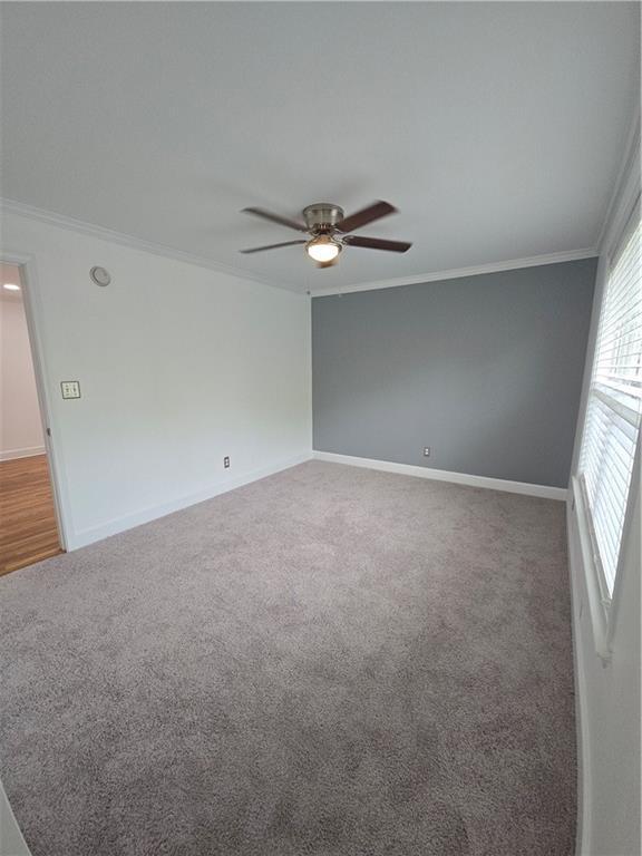 48 Peachtree Ave NE Unit 321, Atlanta, GA 30305 - carpeted empty room featuring crown molding and ceiling fan