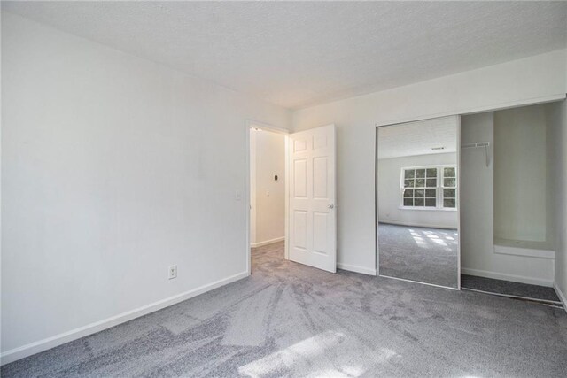 1025 Lakeside Cir, Covington, GA 30016 - empty room with carpet floors, baseboards, and a textured ceiling