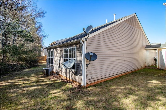 1025 Lakeside Cir, Covington, GA 30016 - view of home's exterior featuring cooling unit and a lawn