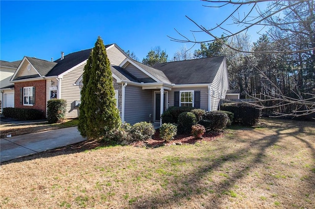 1025 Lakeside Cir, Covington, GA 30016 - view of side of property with concrete driveway and a yard