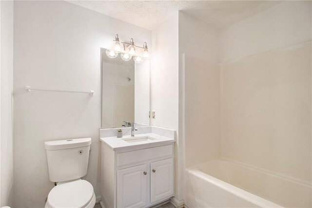 1025 Lakeside Cir, Covington, GA 30016 - bathroom with toilet, vanity, shower / bath combination, and a textured ceiling