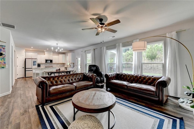 5215 Wheeler Run Dr, Auburn, GA 30011 - living area featuring a chandelier, baseboards, a ceiling fan, light wood-style flooring, and recessed lighting