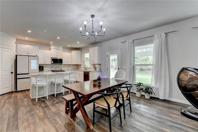 5215 Wheeler Run Dr, Auburn, GA 30011 - dining area with a chandelier, dark wood-type flooring, recessed lighting, and baseboards