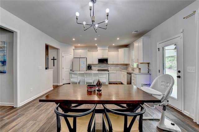 5215 Wheeler Run Dr, Auburn, GA 30011 - dining room featuring a chandelier, wood finished floors, baseboards, and recessed lighting