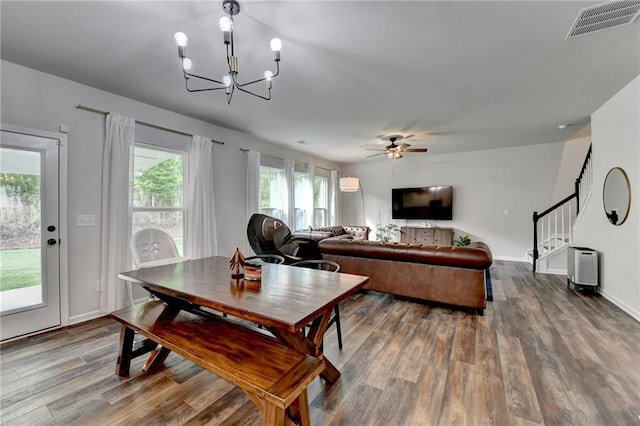 5215 Wheeler Run Dr, Auburn, GA 30011 - dining space featuring wood finished floors, a chandelier, a ceiling fan, stairway, and baseboards