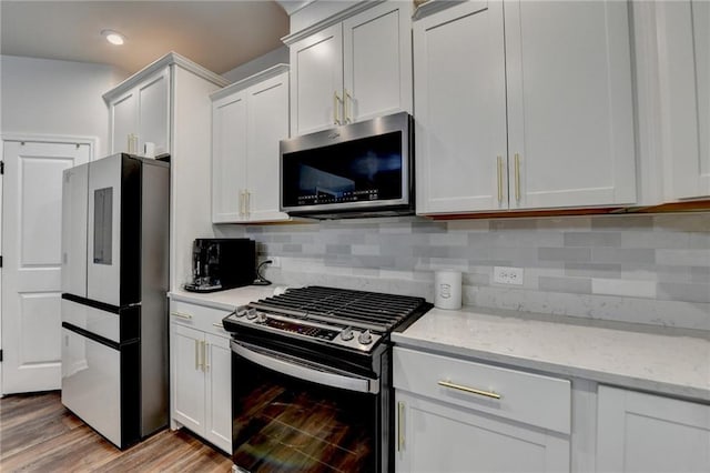 5215 Wheeler Run Dr, Auburn, GA 30011 - kitchen with stainless steel appliances, light wood-style floors, light stone countertops, tasteful backsplash, and white cabinetry