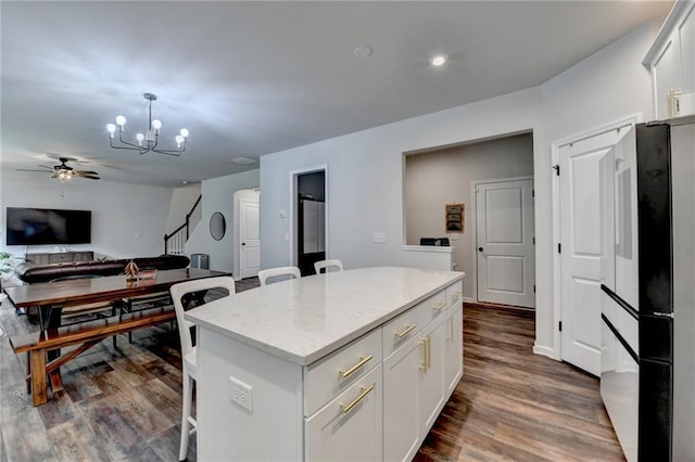 5215 Wheeler Run Dr, Auburn, GA 30011 - kitchen with freestanding refrigerator, a chandelier, dark wood-type flooring, and a center island