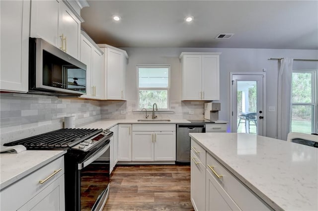 5215 Wheeler Run Dr, Auburn, GA 30011 - kitchen featuring stainless steel appliances, a sink, dark wood-style floors, healthy amount of natural light, and recessed lighting