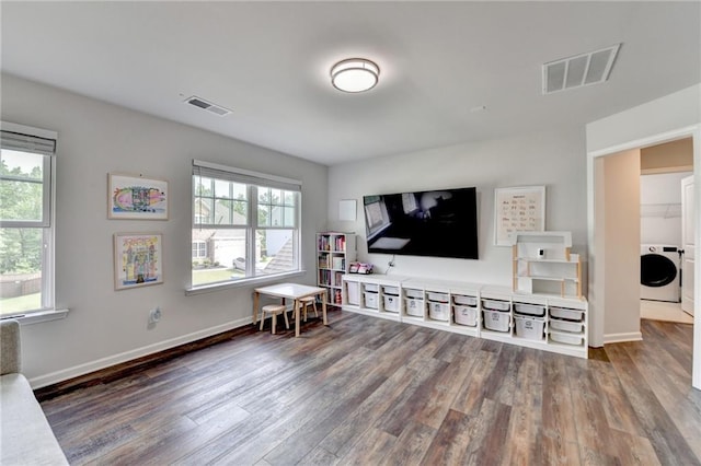 5215 Wheeler Run Dr, Auburn, GA 30011 - living area with washer / dryer, wood finished floors, and plenty of natural light