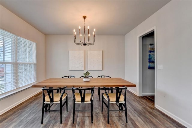 5215 Wheeler Run Dr, Auburn, GA 30011 - dining space with a chandelier, baseboards, and dark wood finished floors