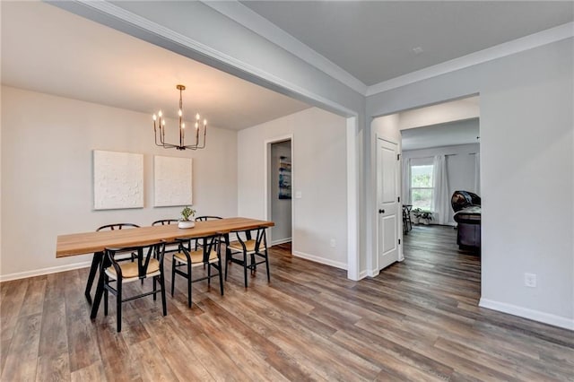 5215 Wheeler Run Dr, Auburn, GA 30011 - dining room with a chandelier, wood finished floors, baseboards, and crown molding