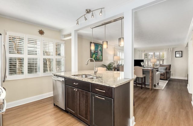 kitchen with pendant lighting, dishwasher, sink, dark brown cabinetry, and crown molding