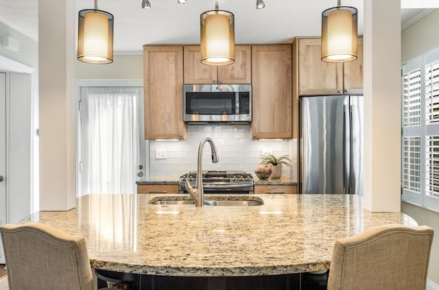 kitchen featuring pendant lighting, crown molding, stainless steel appliances, light stone counters, and decorative backsplash