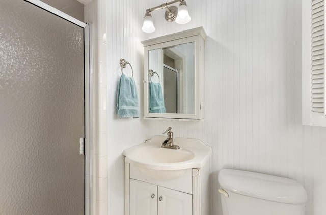 bathroom with vanity, toilet, and walk in shower