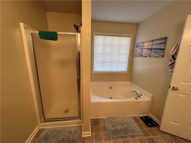 bathroom featuring tile patterned flooring, a textured ceiling, and separate shower and tub