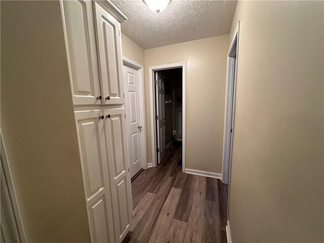 corridor featuring hardwood / wood-style floors and a textured ceiling