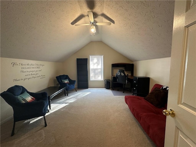 sitting room featuring ceiling fan, carpet floors, a textured ceiling, and vaulted ceiling