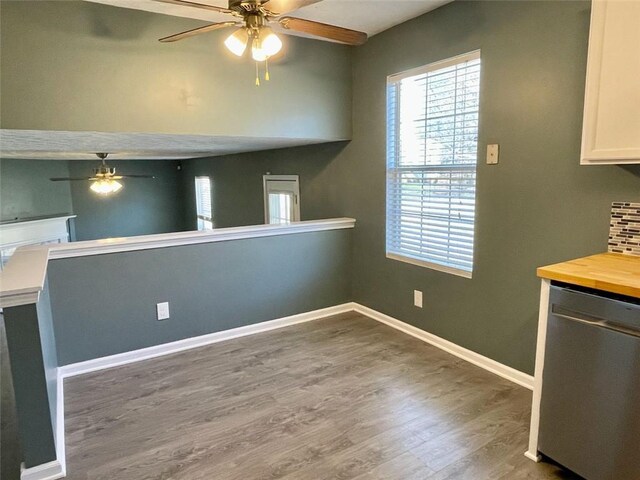 kitchen with backsplash, baseboards, dishwasher, wood finished floors, and a ceiling fan