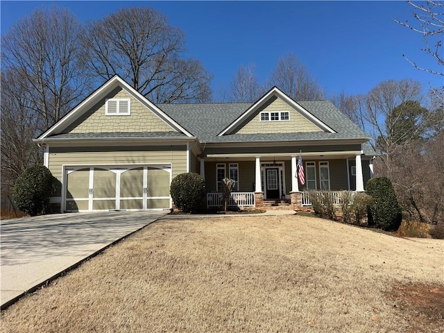 craftsman-style house with a porch, driveway, a shingled roof, and an attached garage